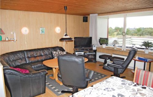 a living room with a couch and chairs and a table at Holiday Home Ringvejen Rømø Iii in Rømø