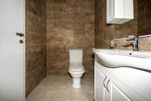 a bathroom with a toilet and a sink at Adria Lux Apartments Sveti Stefan in Budva