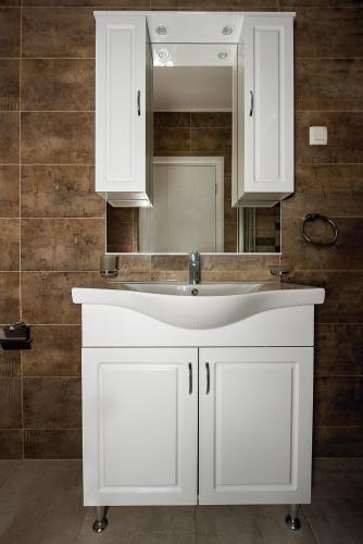 a bathroom with a white sink and a mirror at Adria Lux Apartments Sveti Stefan in Budva