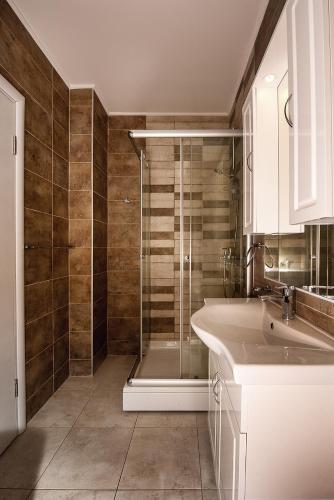 a bathroom with a shower and a sink at Adria Lux Apartments Sveti Stefan in Budva