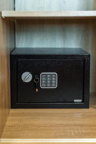a black microwave sitting on top of a shelf at Adria Lux Apartments Sveti Stefan in Budva