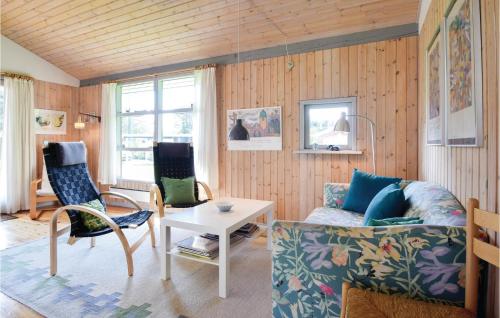 a living room with a couch and chairs and a table at Three-Bedroom Holiday Home In Humble in Humble