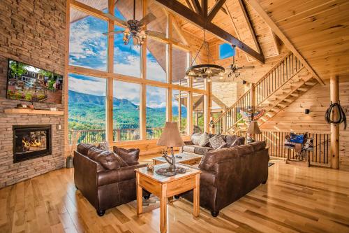 a living room with leather furniture and a fireplace at Star Dancer Cabin in Gatlinburg