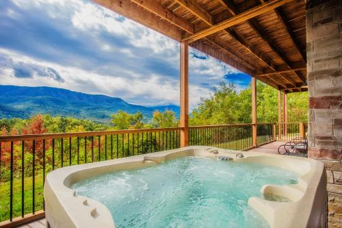 a hot tub on the balcony of a house at Star Dancer Cabin in Gatlinburg