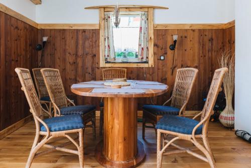 a dining room with a wooden table and chairs at Casa Piedro in Starnberg