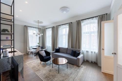 a living room with a couch and a table at Laisves ave. Apartments in Kaunas