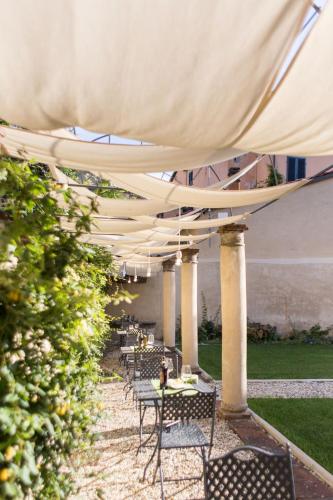 a row of tables and chairs under a tent at LUCUS Exclusive Bed and Breakfast in Lucca