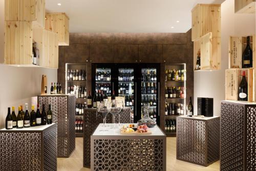 a wine tasting room with two tables and wine bottles at Borgobrufa Spa Resort Adults Only in Brufa