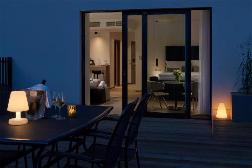 a dining table and chairs in a room with a bedroom at Hotel Passage in Brno