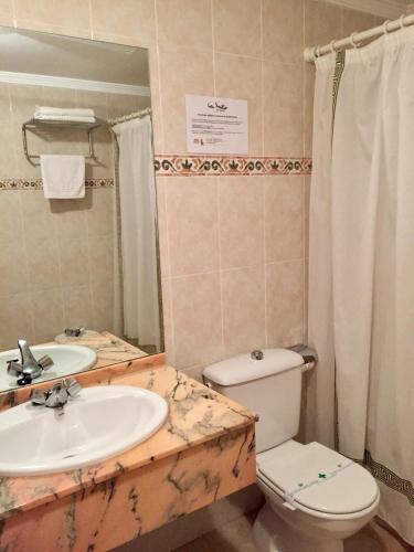 a bathroom with a sink and a toilet at Casa Emilio in Torre Baja
