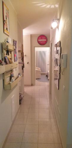 a hallway of a room with a tile floor at PIANO TERRA CON GIARDINO VICINO AL MARE in Viareggio