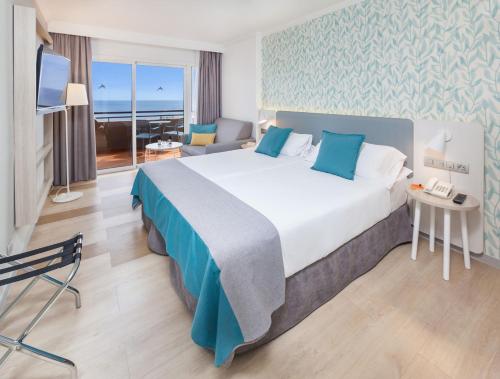 a hotel room with a large bed and a view of the ocean at Abora Continental by Lopesan Hotels in Playa del Ingles