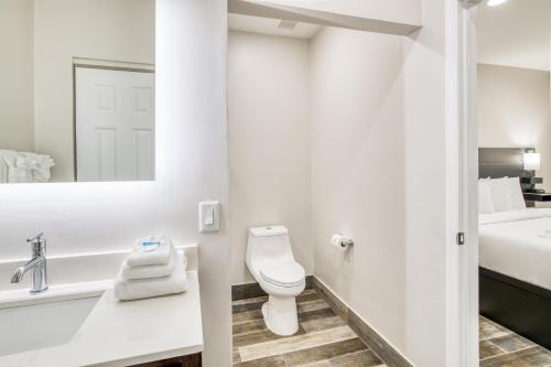 a white bathroom with a toilet and a sink at Villa 1565 - Saint Augustine in Saint Augustine