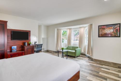 a hotel room with a bed and a television at Villa 1565 - Saint Augustine in Saint Augustine