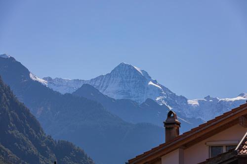 a view of a snow covered mountain from a house at Schilthorn Apartment - Aare Jungfrau AG in Wilderswil