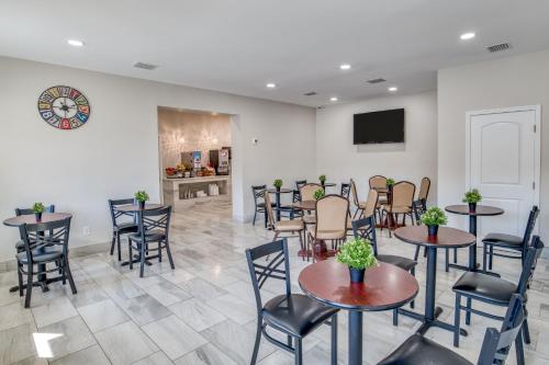 a waiting room with tables and chairs and a tv at Villa 1565 - Saint Augustine in Saint Augustine