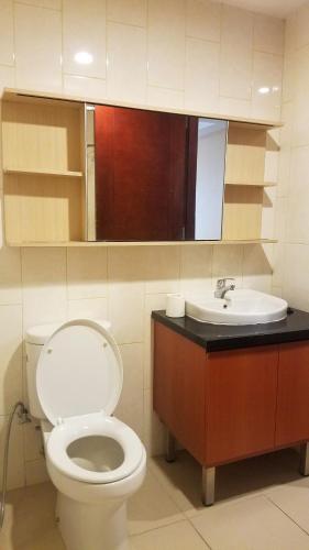 a bathroom with a toilet and a sink at Lavenderbnb Room 10 at Mataram City Apartment in Yogyakarta