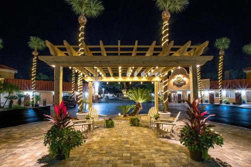 a pavilion with chairs and palm trees at night at Villa 1565 - Saint Augustine in Saint Augustine