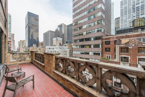 a balcony with a bench and a city skyline at Lombardy Hotel in New York