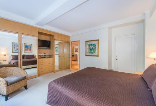 a hotel room with a bed and a chair at Lombardy Hotel in New York