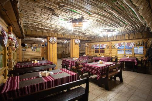 a restaurant with tables and chairs in a room at Nebokrai in Yaremche