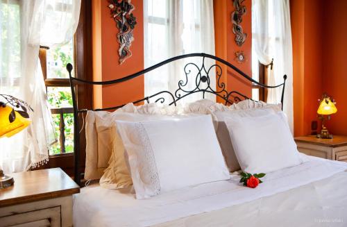 a bed with white pillows and a strawberry on it at Villa Virginaki in Portariá