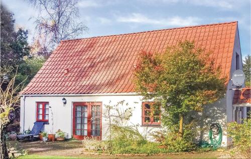 a small white house with an orange roof at Three-Bedroom Holiday Home In Orsted in Udbyhøj