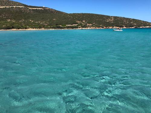 a large body of water with a boat in it at Blue House, 300m to beach in Pula