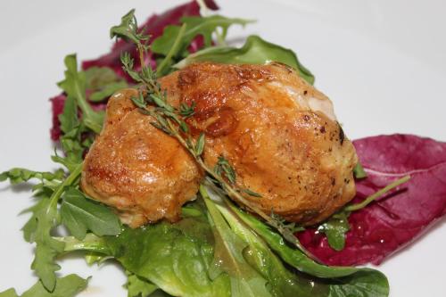 a plate of food with chicken on a salad at The Moosbach Garden in Nordrach