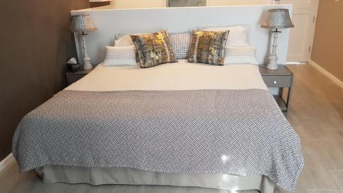 a bedroom with a large bed with two night stands at HORIZON BAY - Camps Bay in Cape Town