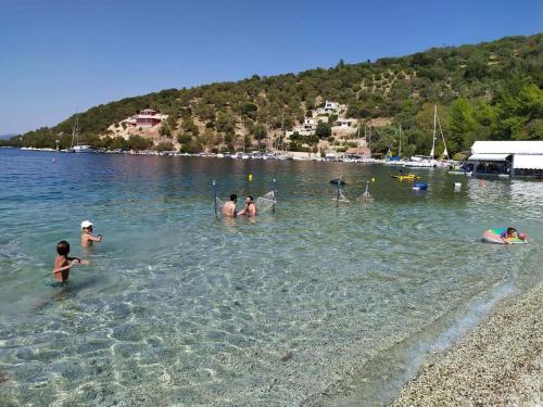 a group of people in the water at a beach at Meganisi Blue apartment in Meganisi