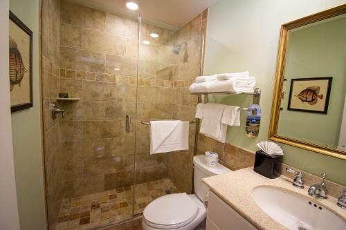 a bathroom with a shower and a toilet and a sink at Vanderbilt Beach Resort in Naples