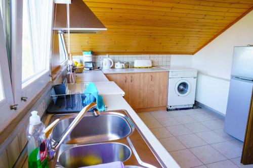 a kitchen with a sink and a washing machine at Kassiani House in Ioannina
