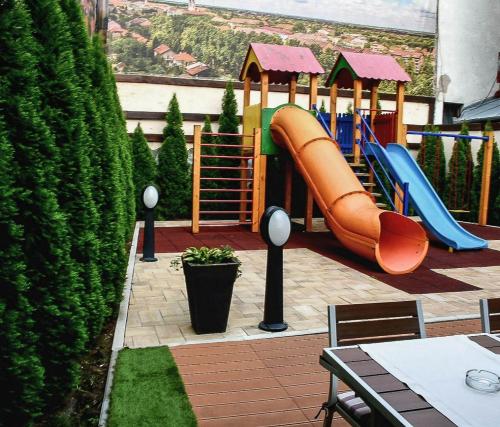 a childrens playground with a slide and a slideintend at Stari Slon in Sombor