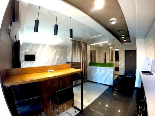 a bar in a restaurant with a counter and chairs at River Park apartments in Dnipro
