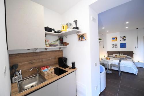 a kitchen with a sink and a bed in a room at B&B IN CENTRO STORICO SALERNO in Salerno