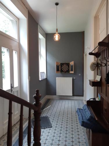 a hallway with a staircase with a stair at La Maison du Maître in Dinant