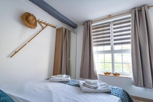 a bedroom with a bed and a window at La Dimiere - Le Postel - Appartements de standing en hyper-centre - Louviers in Louviers