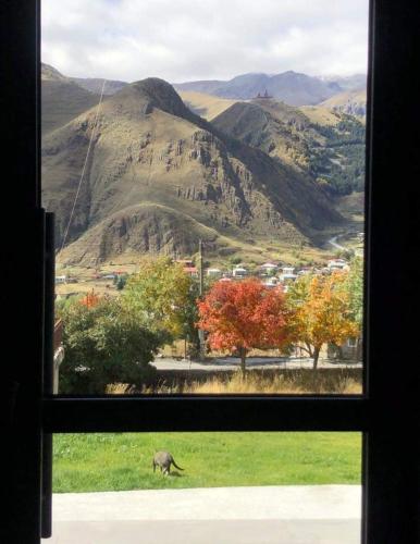 a view of a mountain view from a window at Hilltop Kazbegi in Stepantsminda