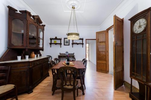 a dining room with a table and a clock on the wall at Jaume II in Llucmajor