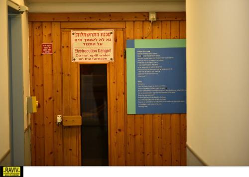 a wooden door with a sign on it at Royal Suite Caesarea in Caesarea