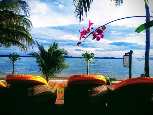 a view of the ocean from a resort with palm trees at Serenity Resort Koh Chang in Ko Chang