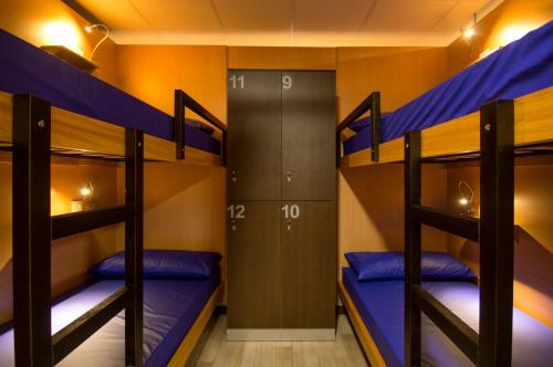 a bunk room with three bunk beds in it at Albergue Piñeiral Fonsagrada in Fonsagrada