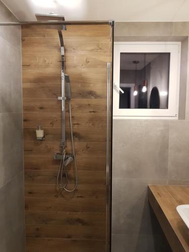 a wooden shower door in a bathroom with a sink at MISVEST Maria IV Arena Gliwice in Gliwice