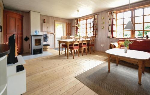 a kitchen and living room with a table and chairs at Holiday Home Hvide Sande 48 in Bjerregård