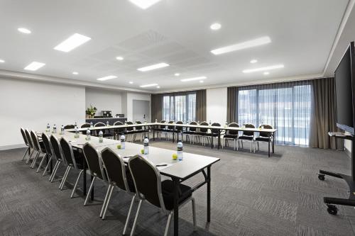 a conference room with a long table and chairs at Quest Orange in Orange