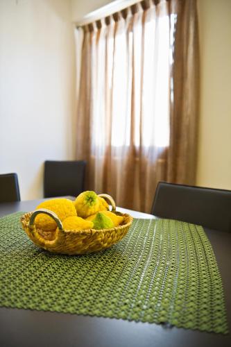 a basket of fruit sitting on top of a table at Bono Vacanze Villa San Marco Luxury Holidays Homes in Sciacca