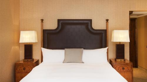 a bedroom with a large bed with two lamps at Lake Arrowhead Resort & Spa in Lake Arrowhead