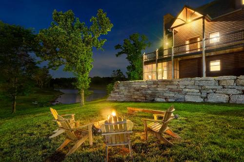a fire pit in front of a house at night at Luxury Lakefront Chalet Resort 2 Pools FREE Amenities Dock MiniGolf Waterslide in Lampe