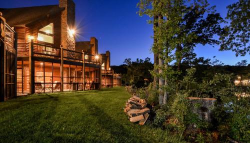 an exterior view of a house with a yard at Luxury Lakefront Chalet Resort 2 Pools FREE Amenities Dock Kayaks Waterslide in Lampe